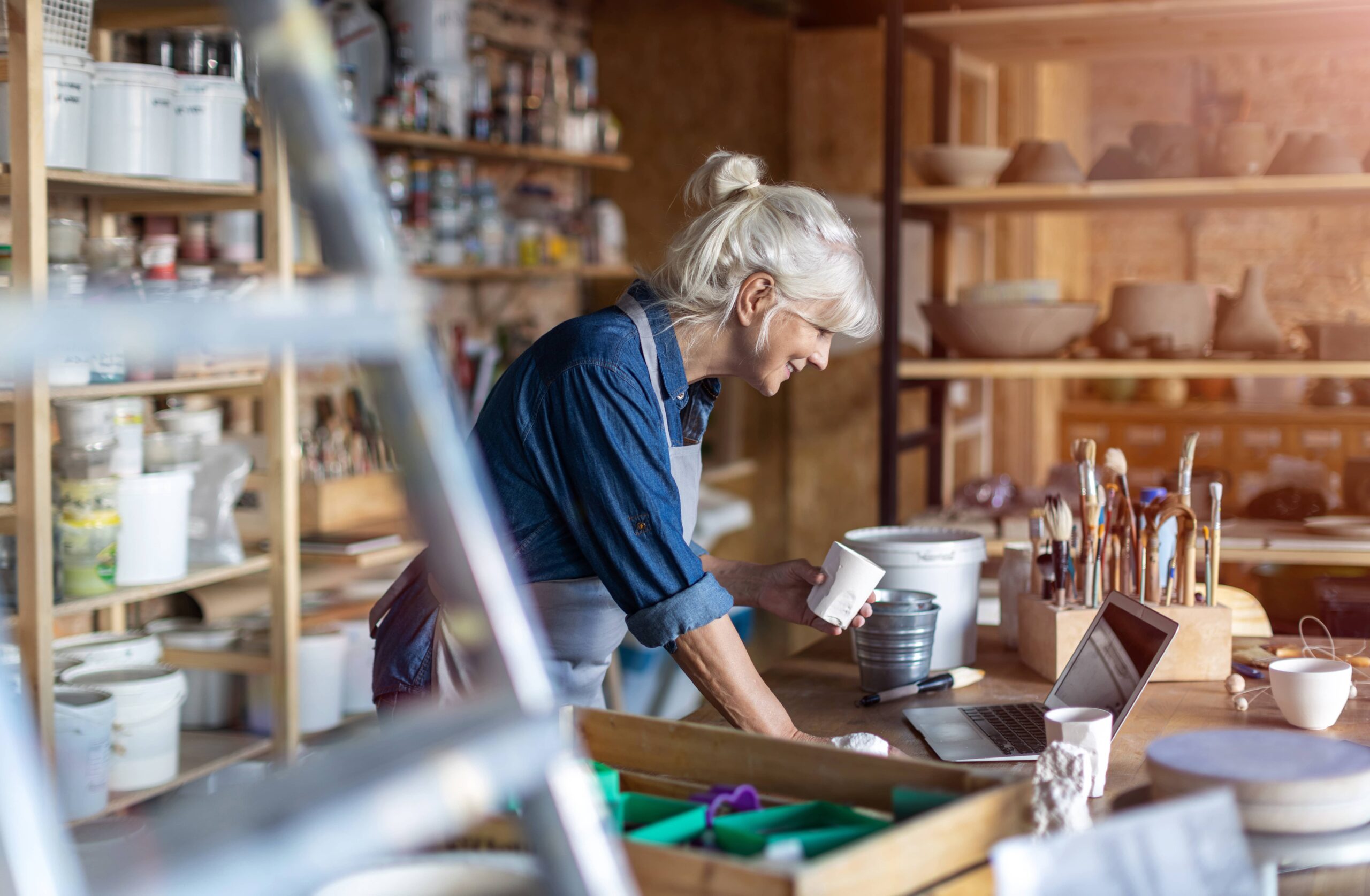 Woman pottery business owner working in her studio
