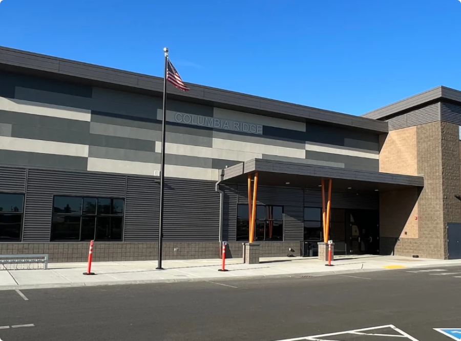 Columbia Ridge ELementary with a flag pole stands under a clear blue sky.