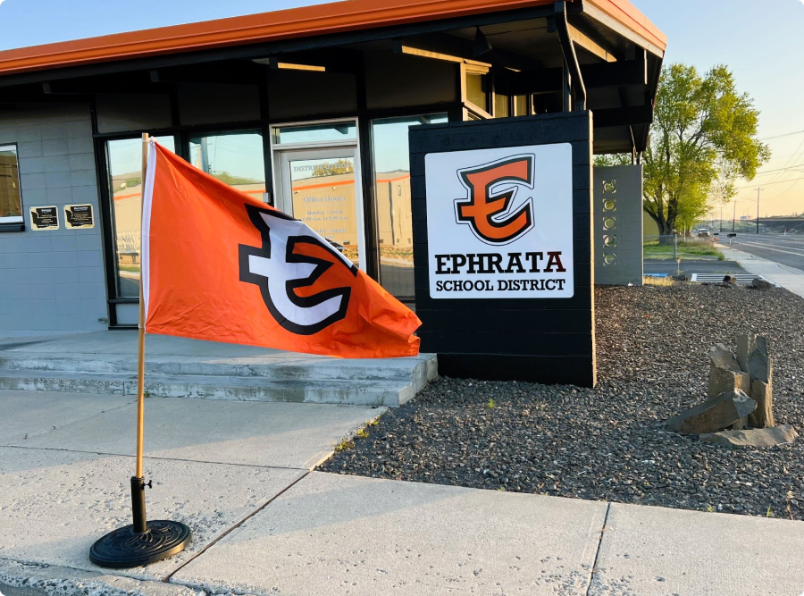building with orange flag on sidewalk