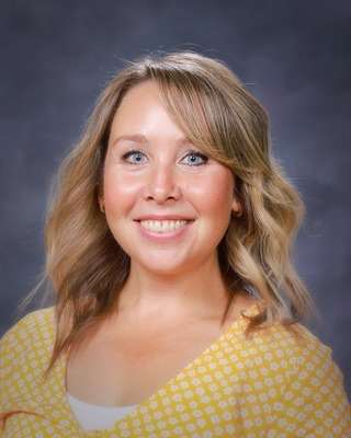 Laina Mitchell wearing a yellow checkered shirt.
