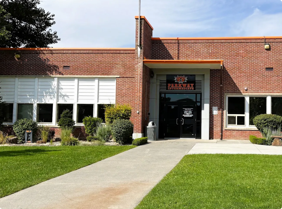 Exterior view of a brick building with a walkway leading to the entrance.