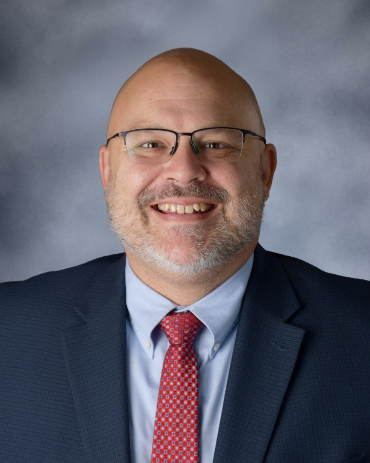 High School Principal smiling for a photo