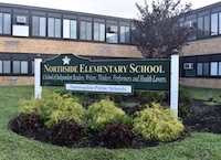 The sign for Northside Elementary School stands in front of the building.