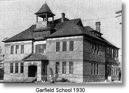 A vintage black and white photo of Garfield School, dated 1930.