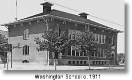 A historic brick school building, Washington School, is shown in black and white.