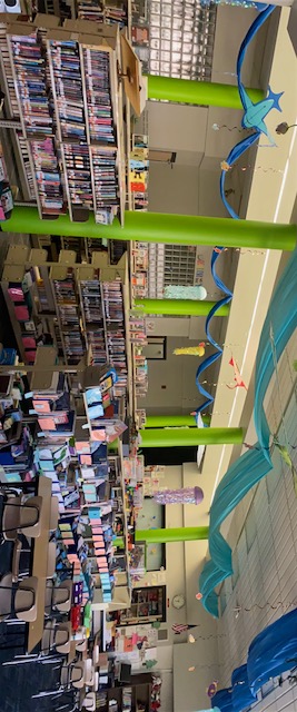 A library interior with bookshelves and decorative elements.