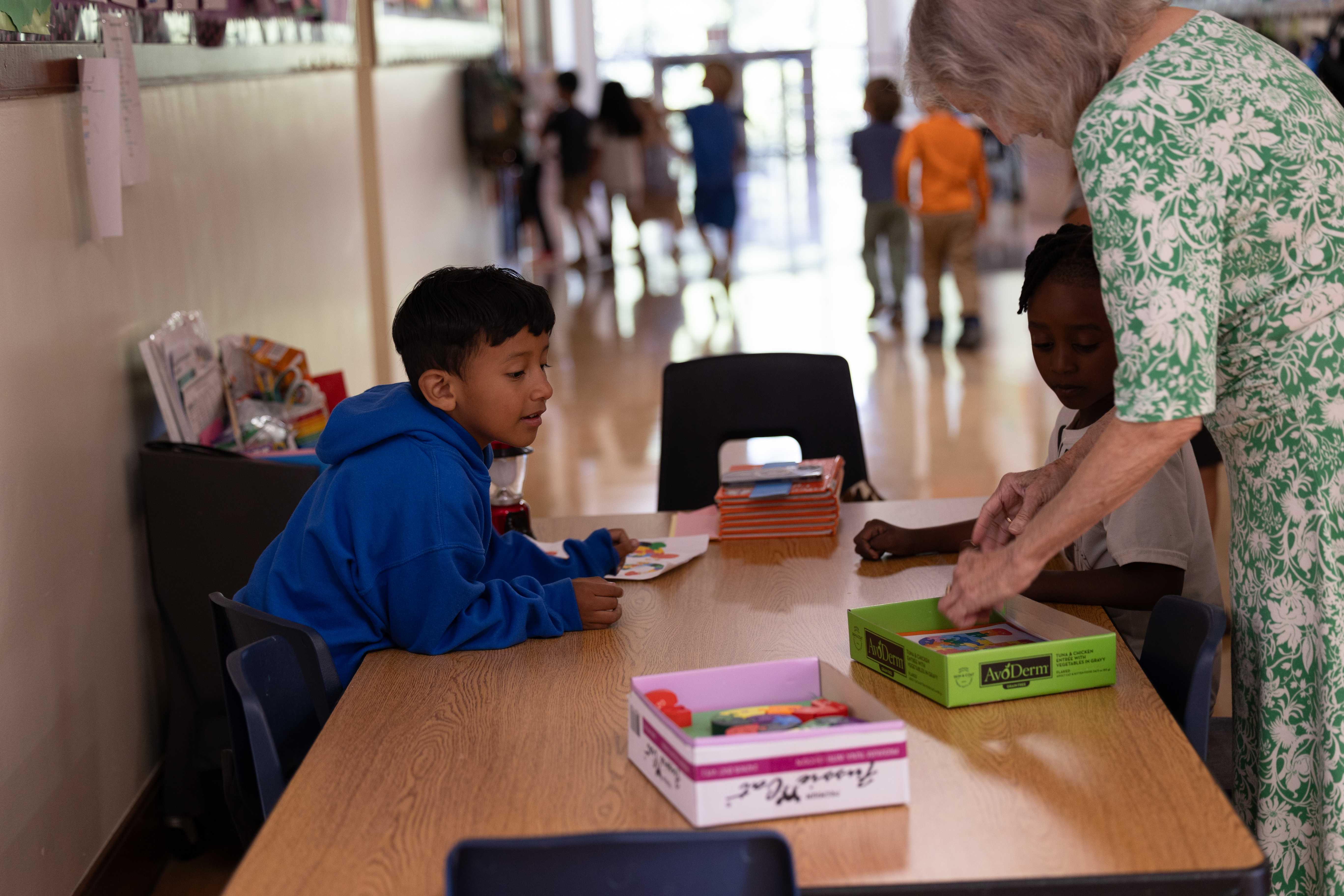 Child working with teacher at a table