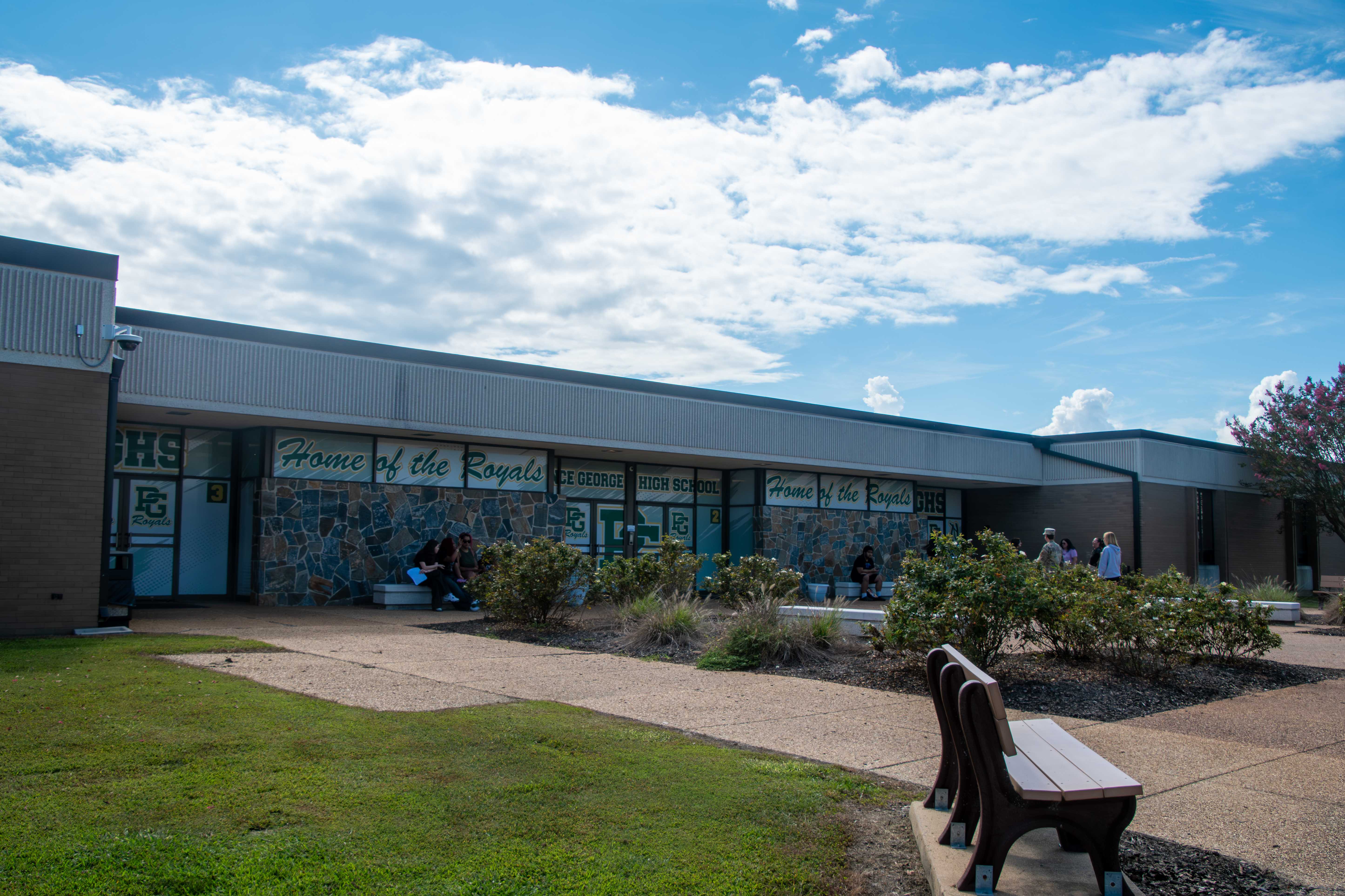 A modern building with large windows and a landscaped courtyard.