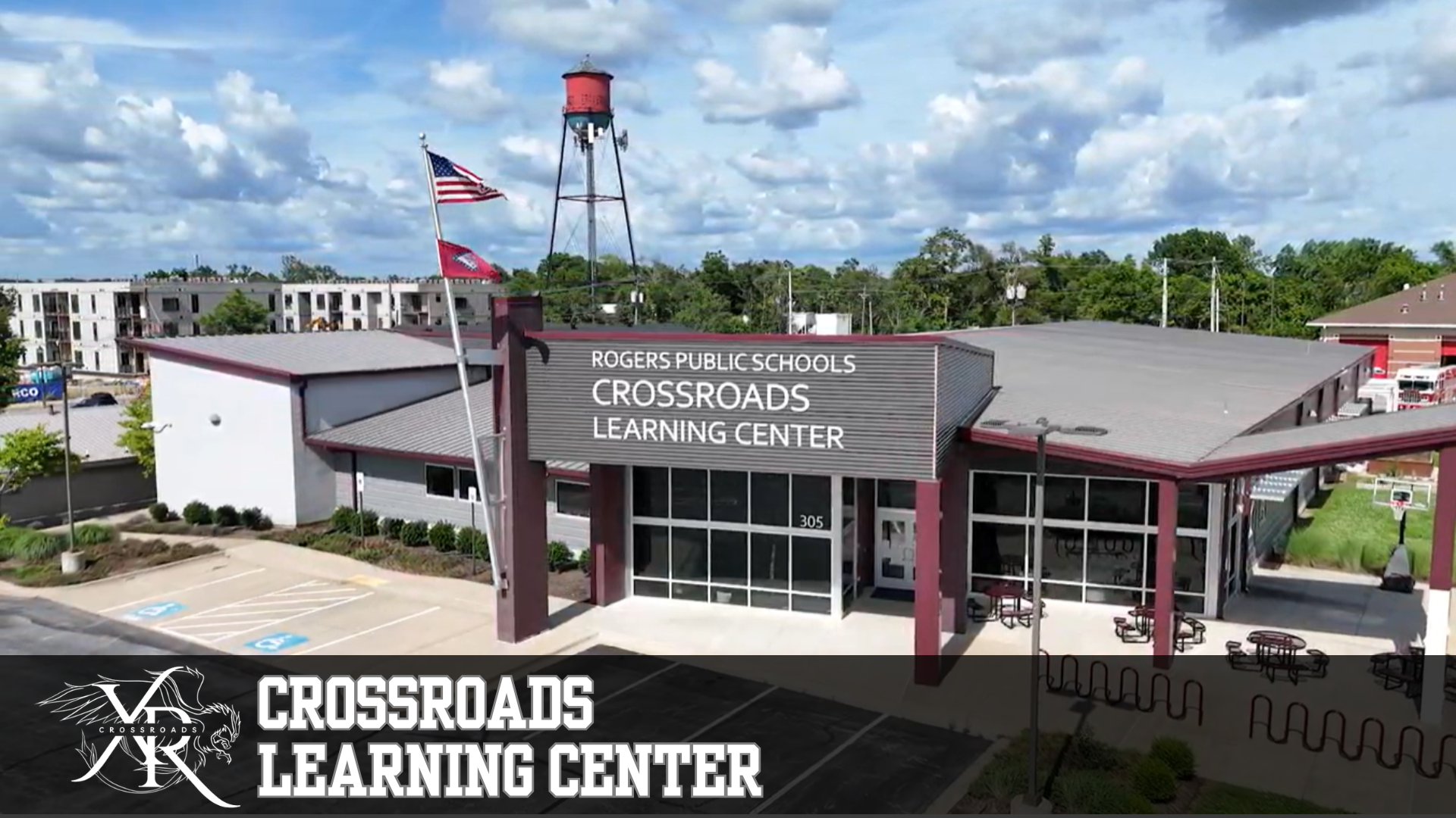 Aerial view of the Crossroads Learning Center building with a water tower in the background.