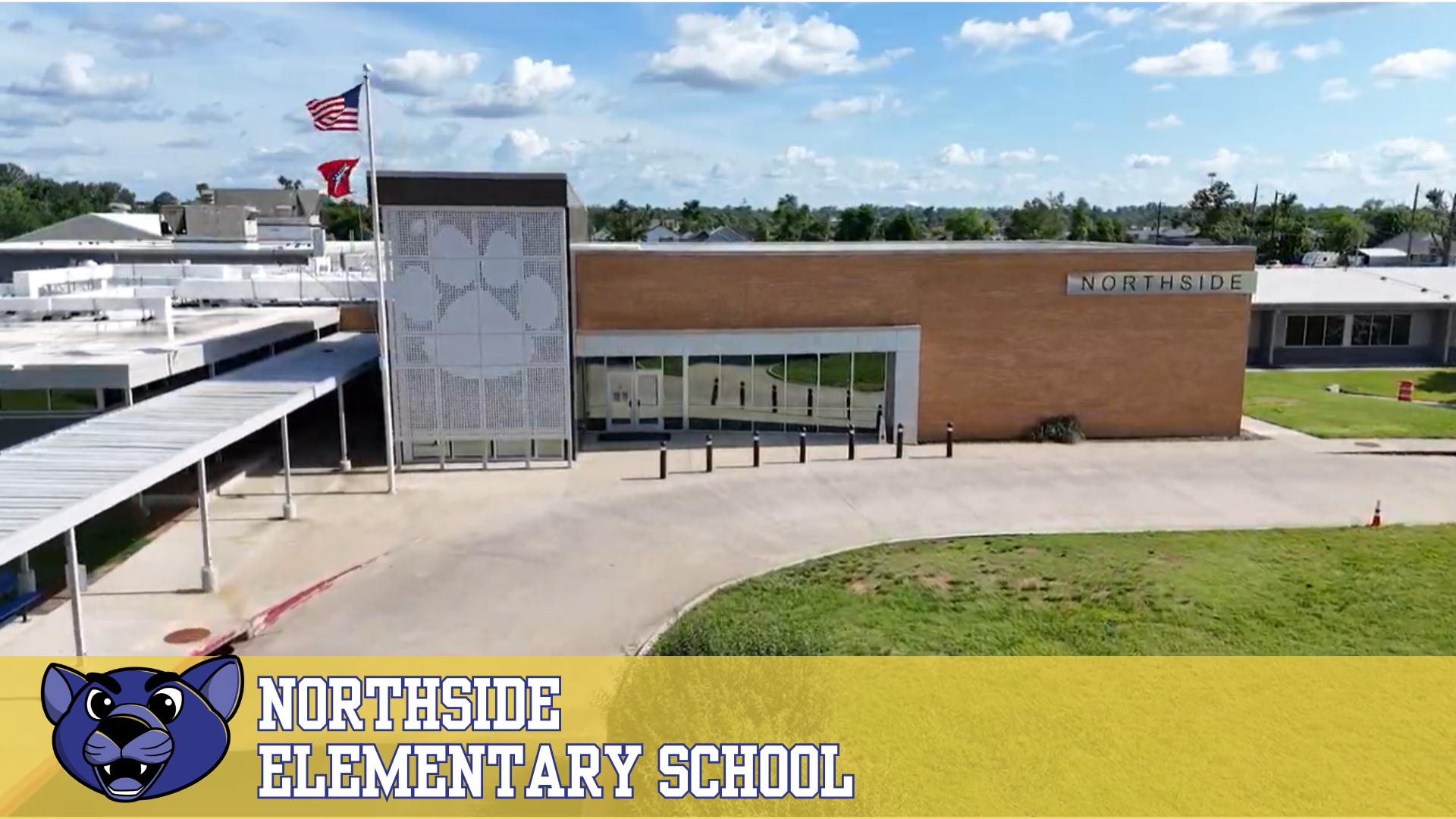 Exterior view of Northside Elementary School with a large paw print logo on the building.
