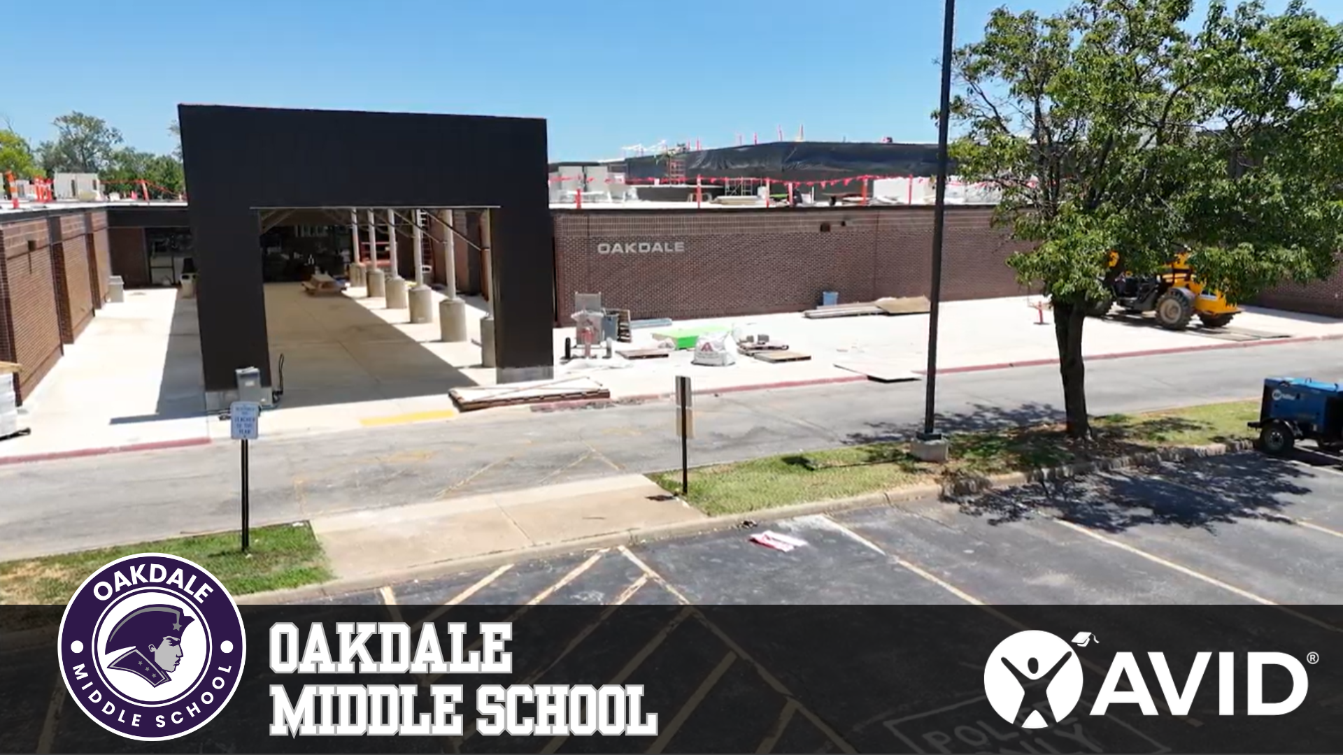Oakdale Middle School building with construction in progress and the AVID logo.