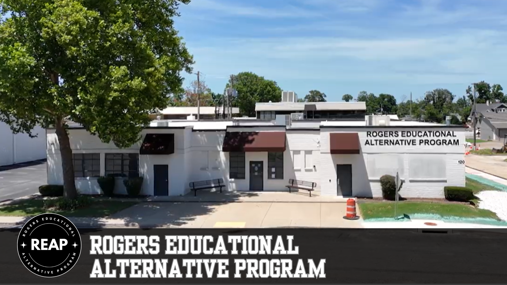 Exterior view of the Rogers Educational Alternative Program building on a sunny day.