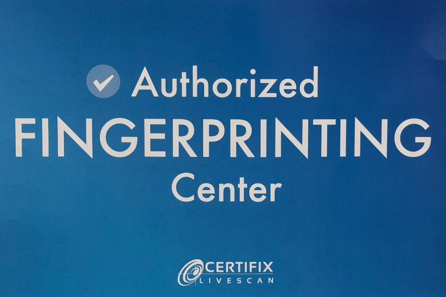 Sign indicating an Authorized Fingerprinting Center with a checkmark.