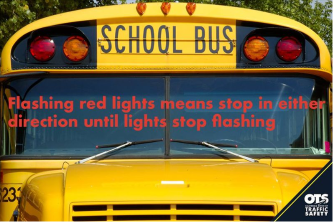 Front view of a yellow school bus with the text 'SCHOOL BUS' above the windshield.