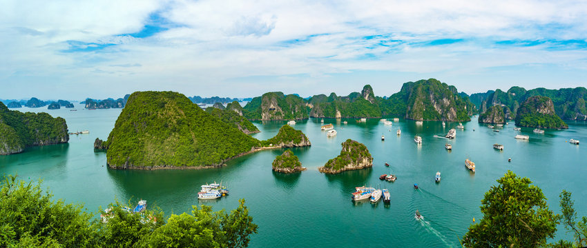 A scenic view of a bay with numerous green islands rising from the water.