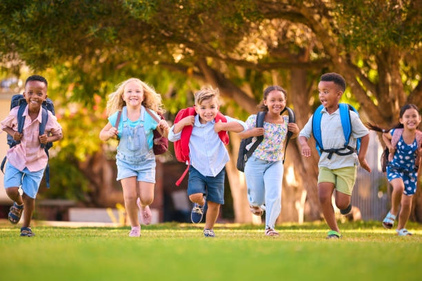 Children running with backpacks