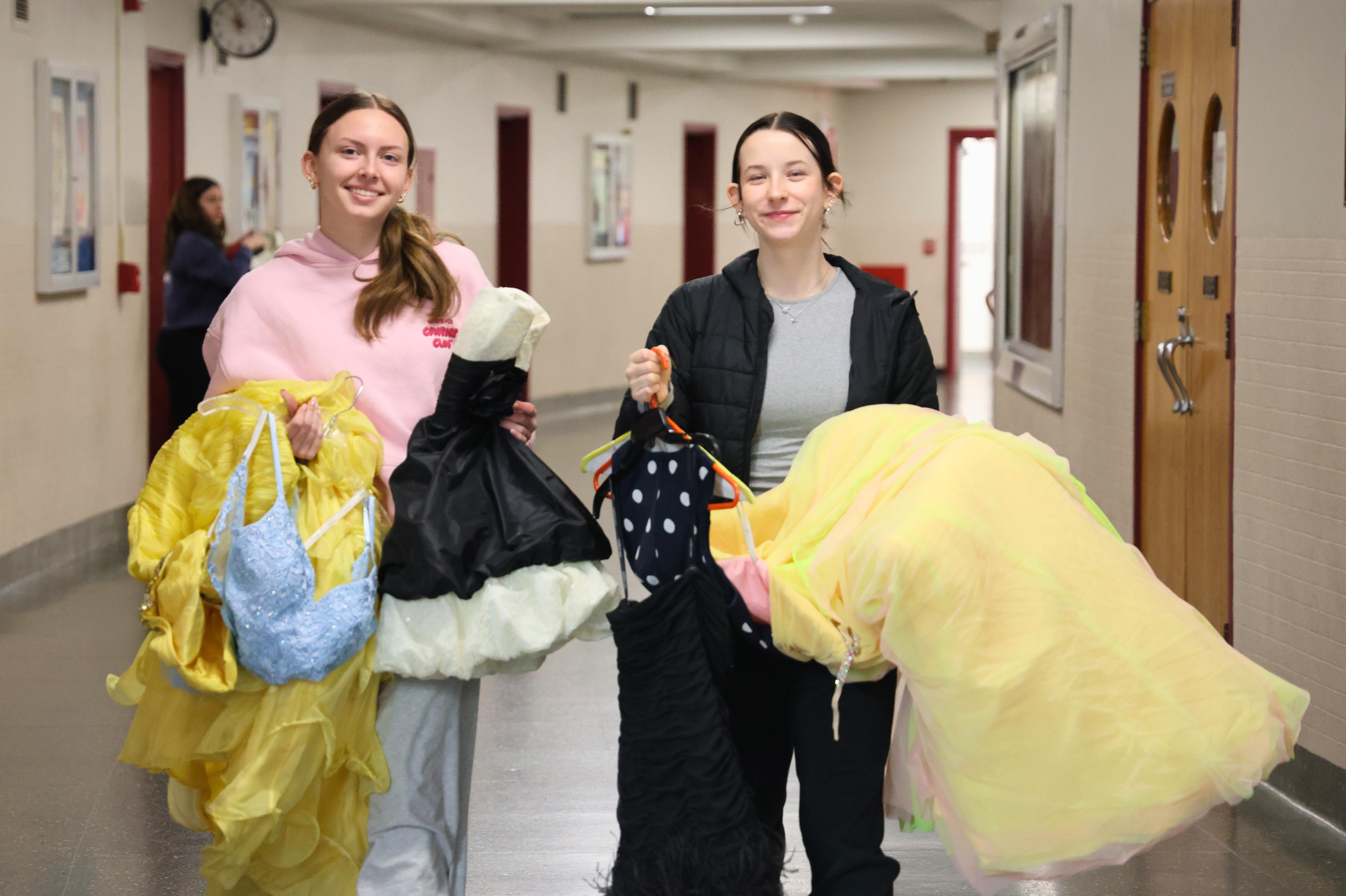 Students bring dresses down hallway