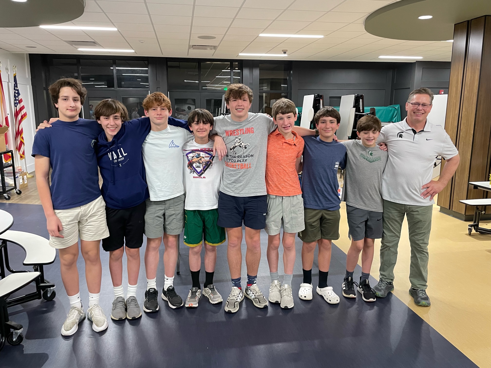 Group photo of a coach with eight boys in the eighth grade