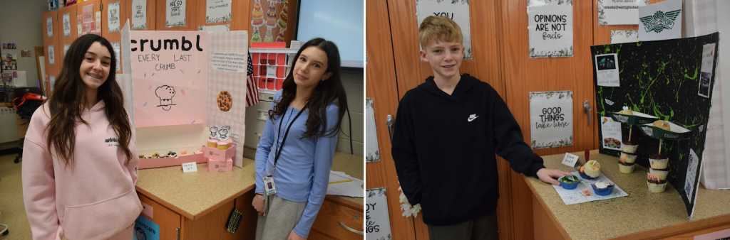 Two students stand by a display board with the word 'crumble' visible.