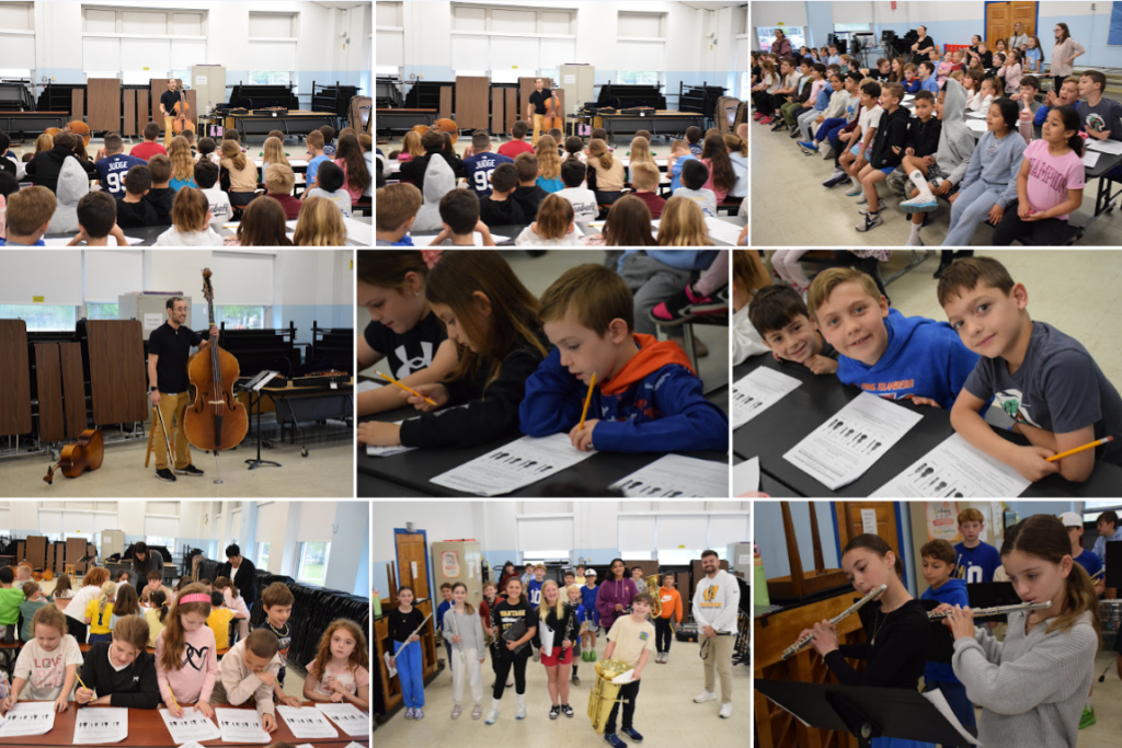 Students in a large room appear to be participating in a music class or performance.