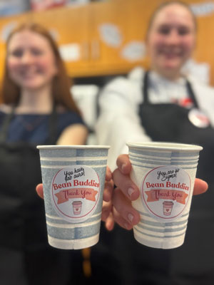 Students show off coffee they made during Bean Buddies.