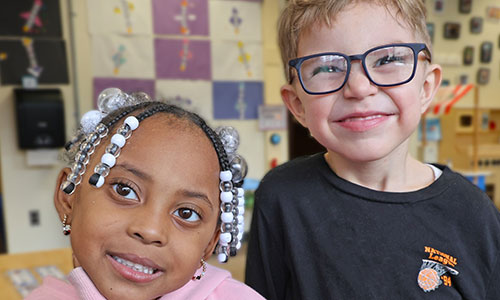 Two smiling UPK students.