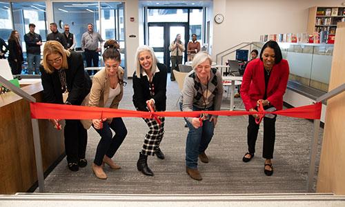 Members of the PCSD community cut the ribbon on the newly redesigned library.