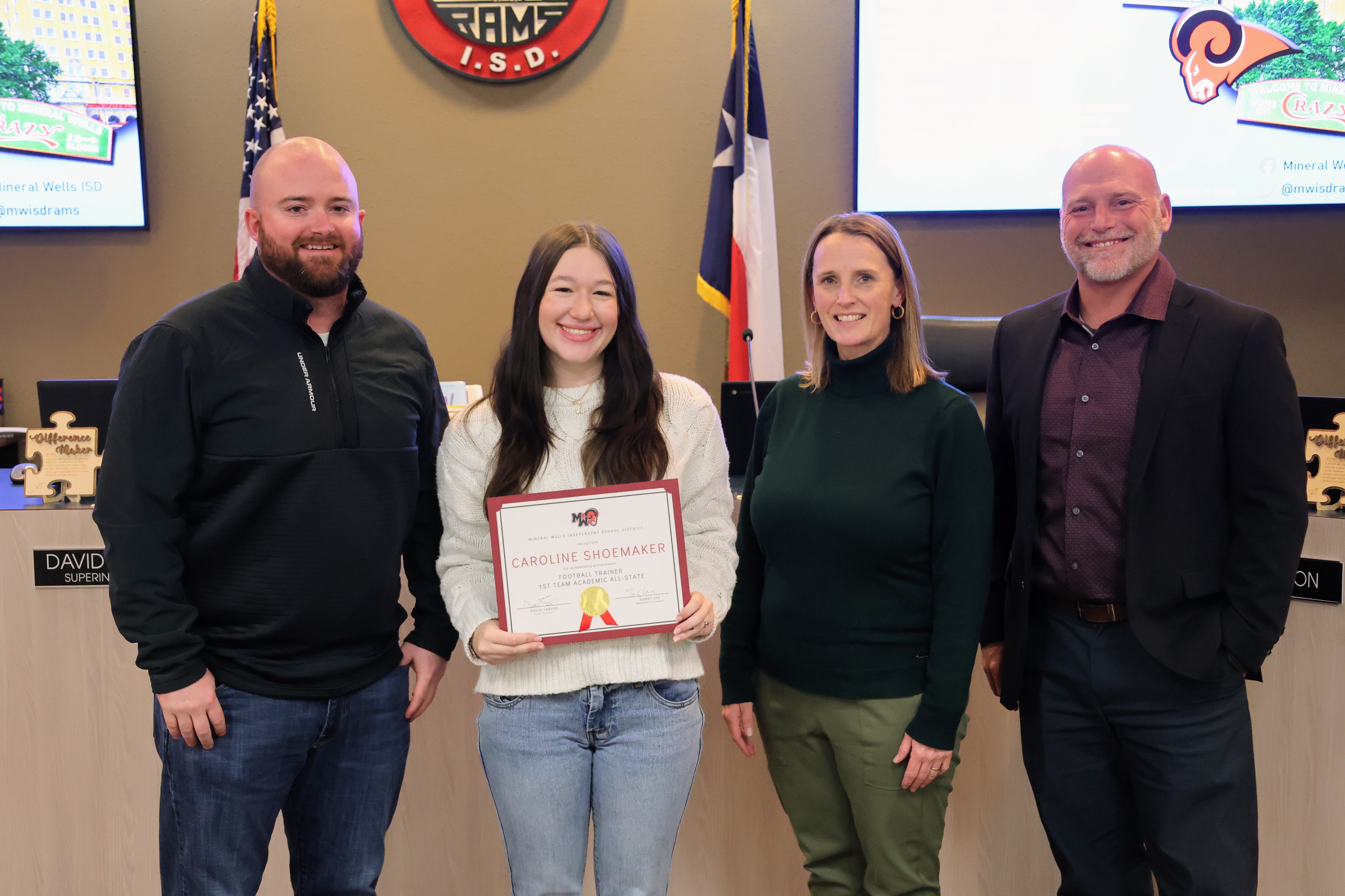 A student sitting at a desk in a classroom.