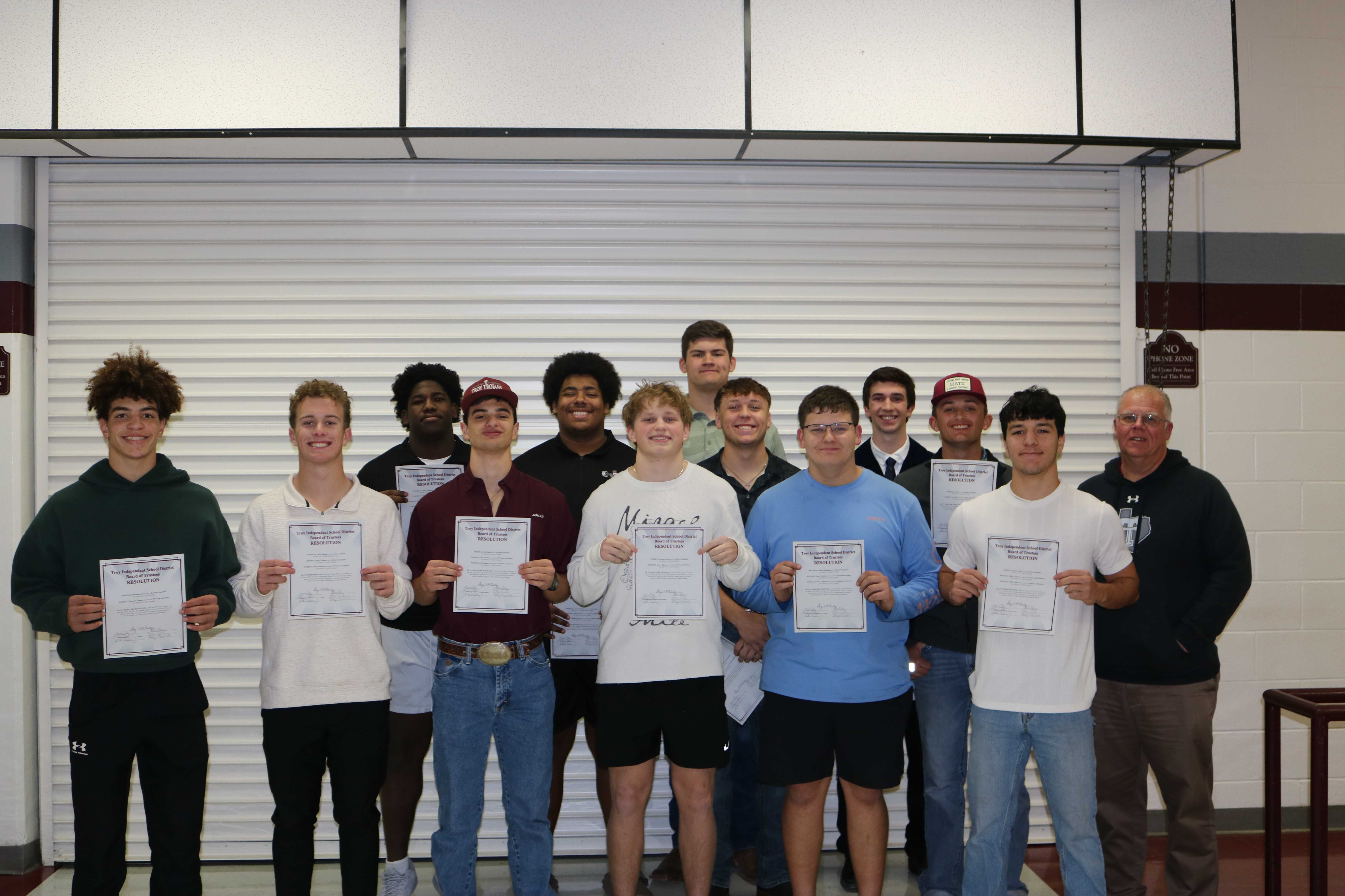 football boys holding awards