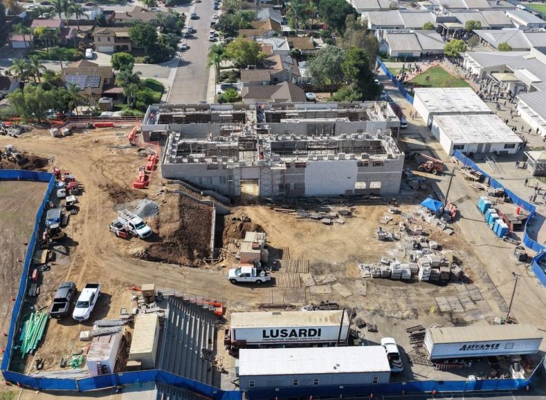 Aerial view of a construction site with partially built structures and equipment.