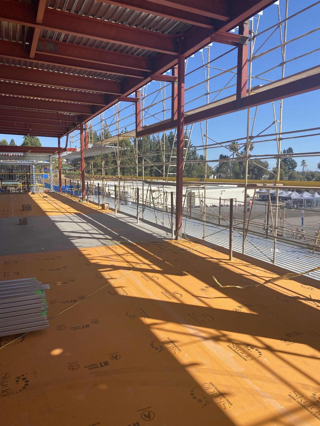 Interior view of a building under construction with exposed steel beams.