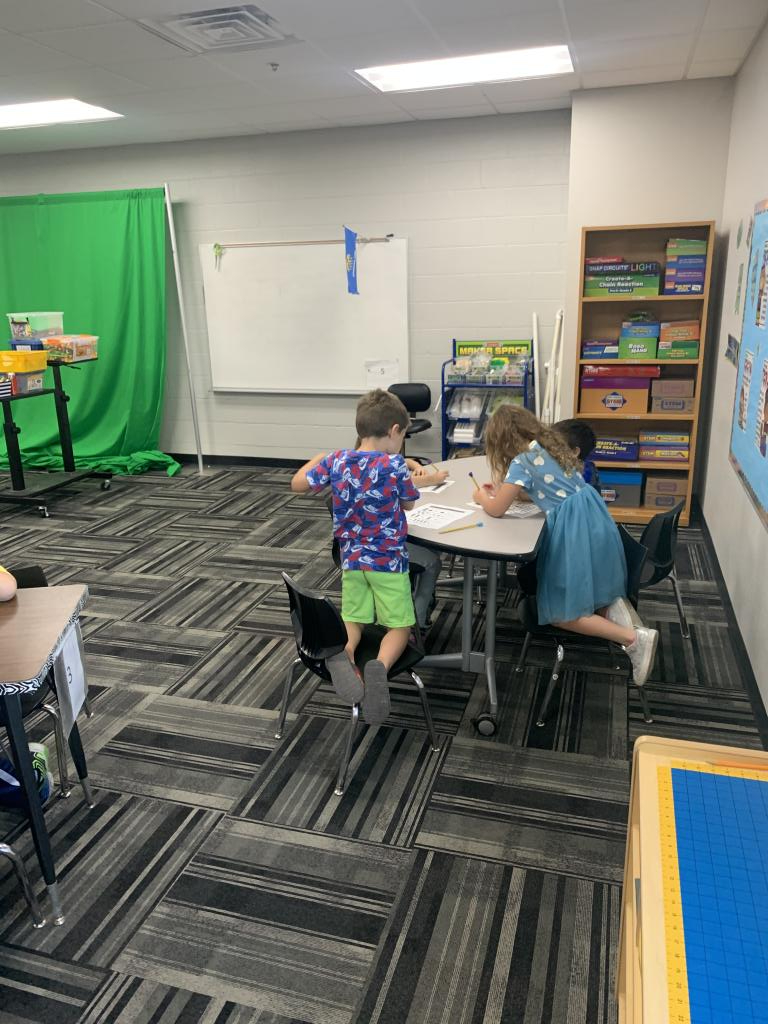 Children at a desk doing classwork