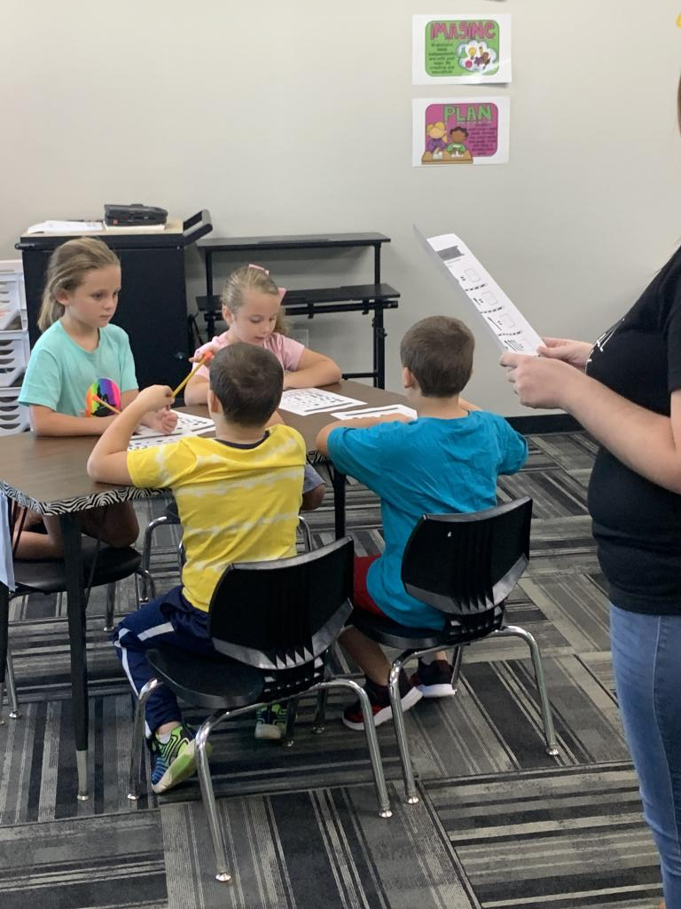 Children at a desk doing classwork