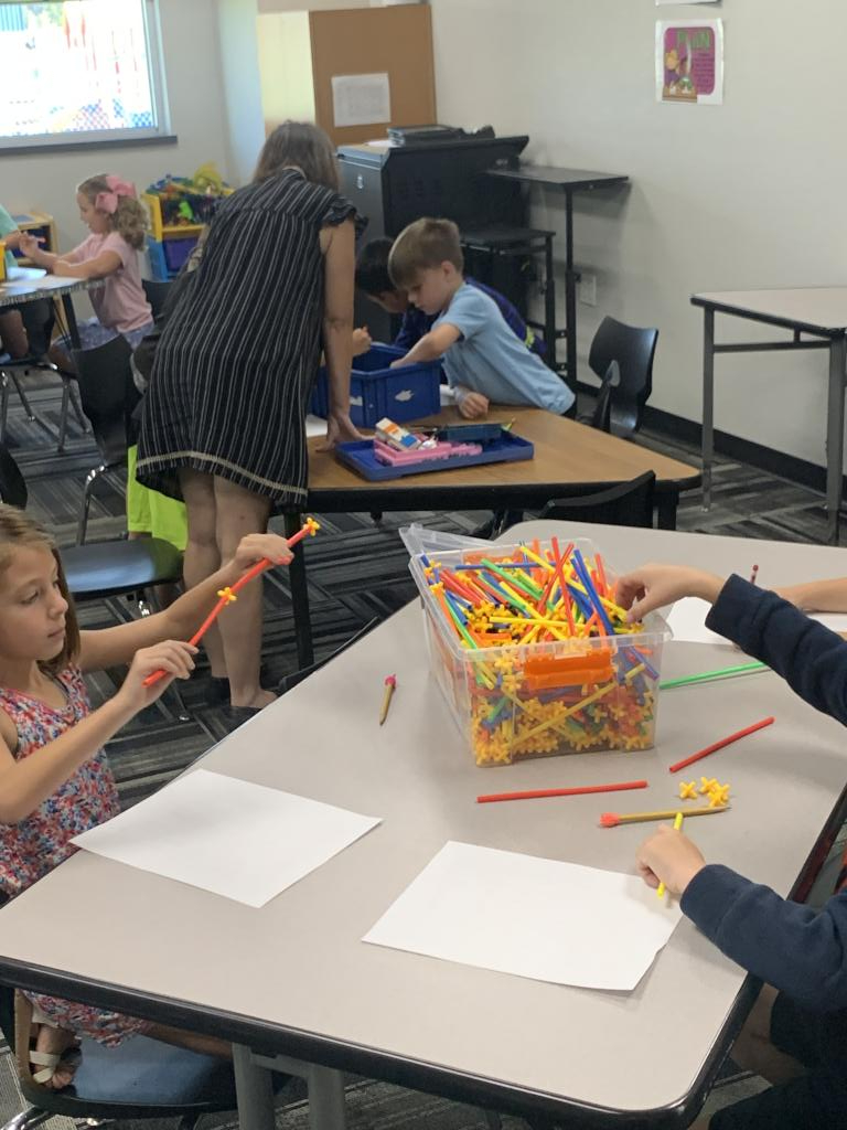 Children and teacher doing a hands on activity together