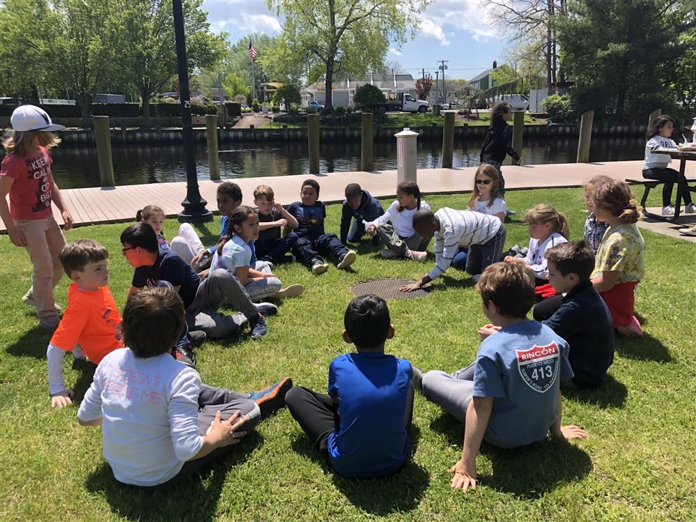 Group of children relaxing on grass.