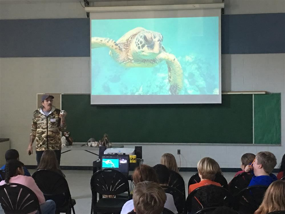 giving a presentation to a group of people, engaging and sharing valuable information.