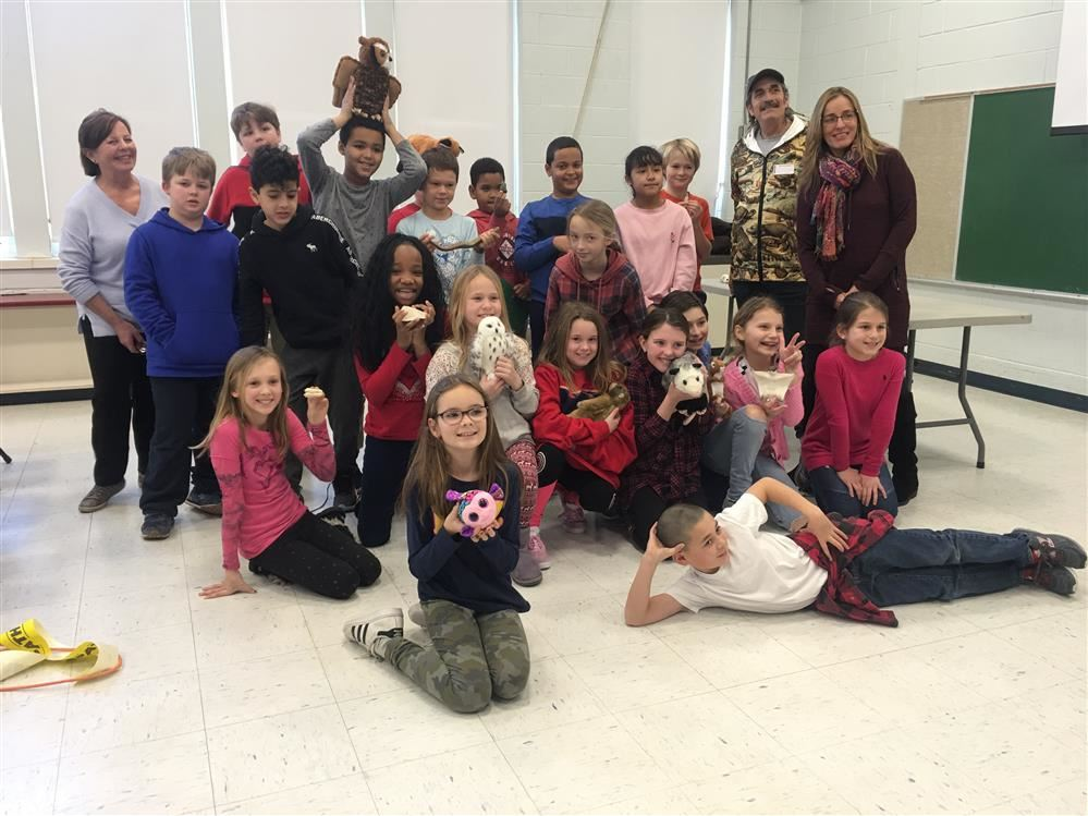 A group of children and adults posing for a picture.