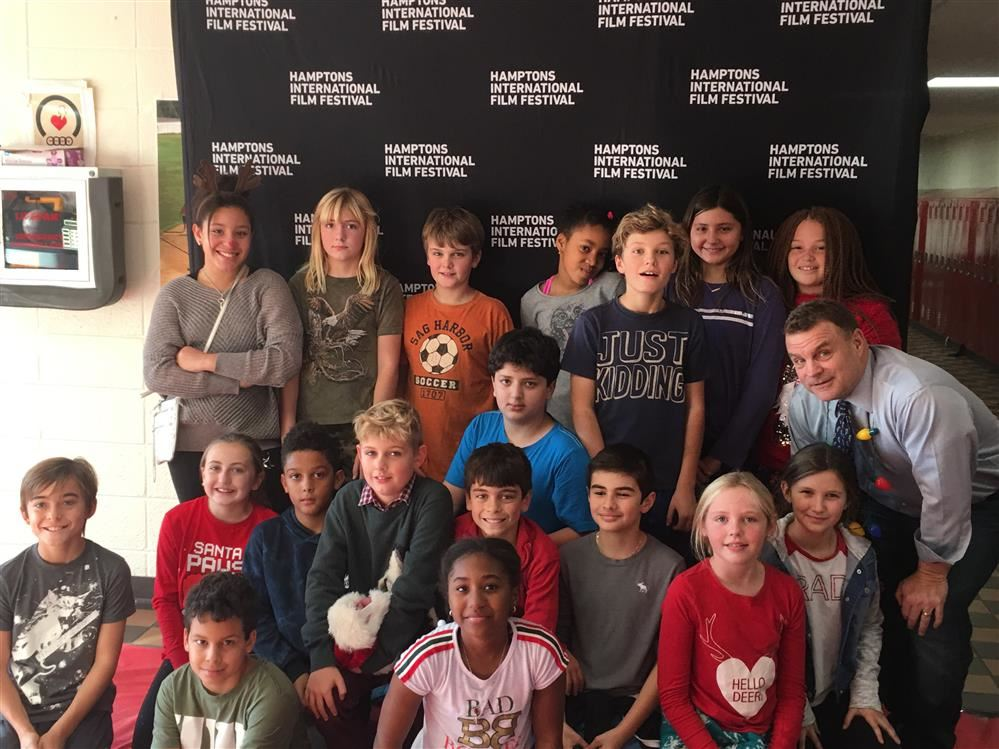 A diverse group of children and adults posing for a photo