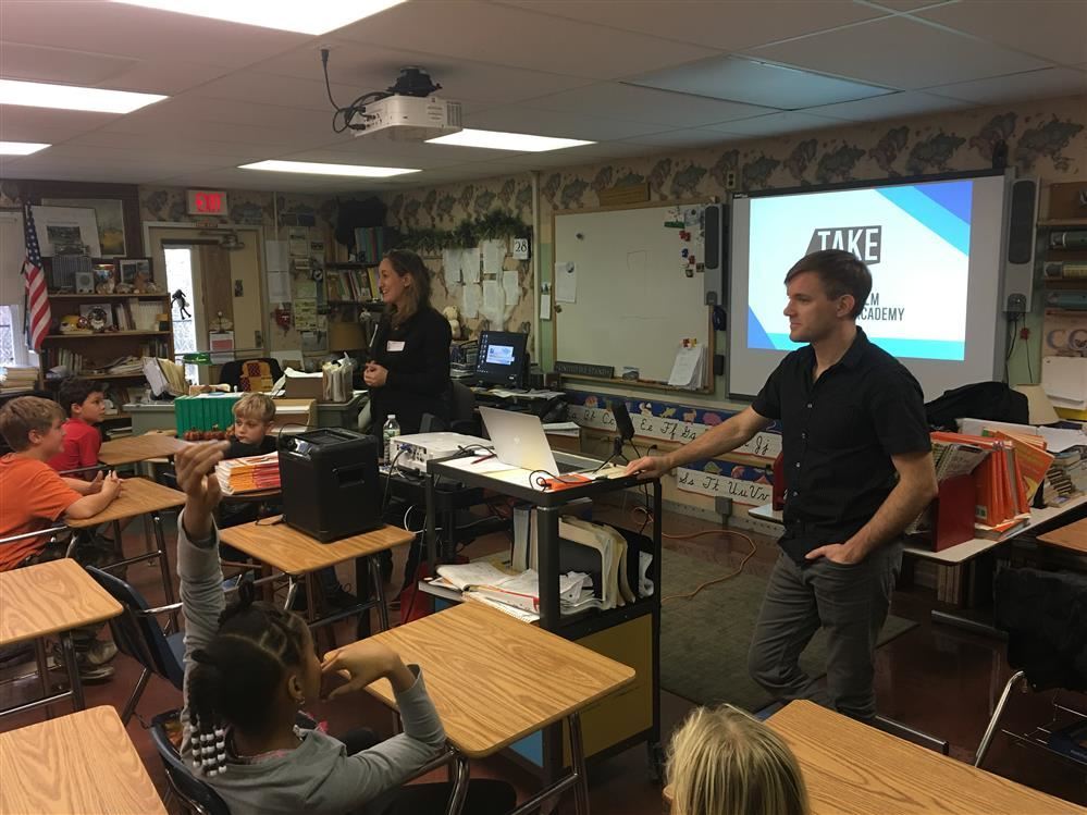 A teacher presenting to students in a classroom