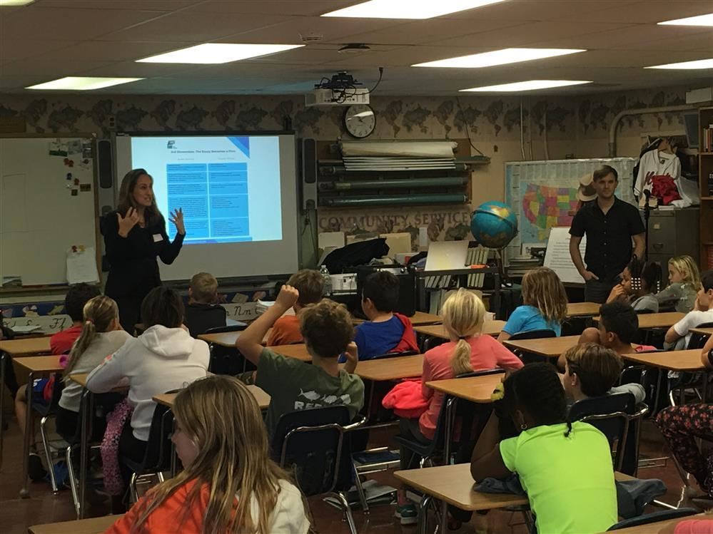 A teacher presenting to a classroom of children