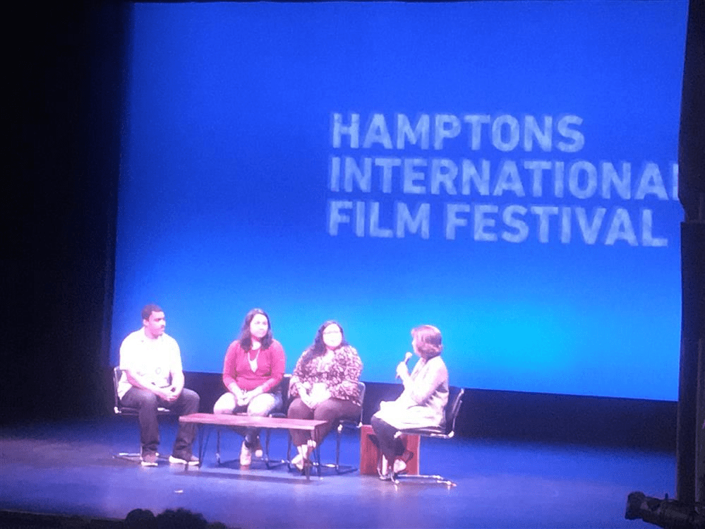 People sitting on stage at Hamptons International Film Festival.