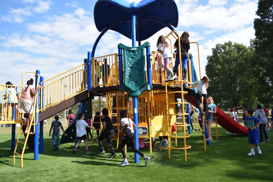 A photo of a playground park and kids.
