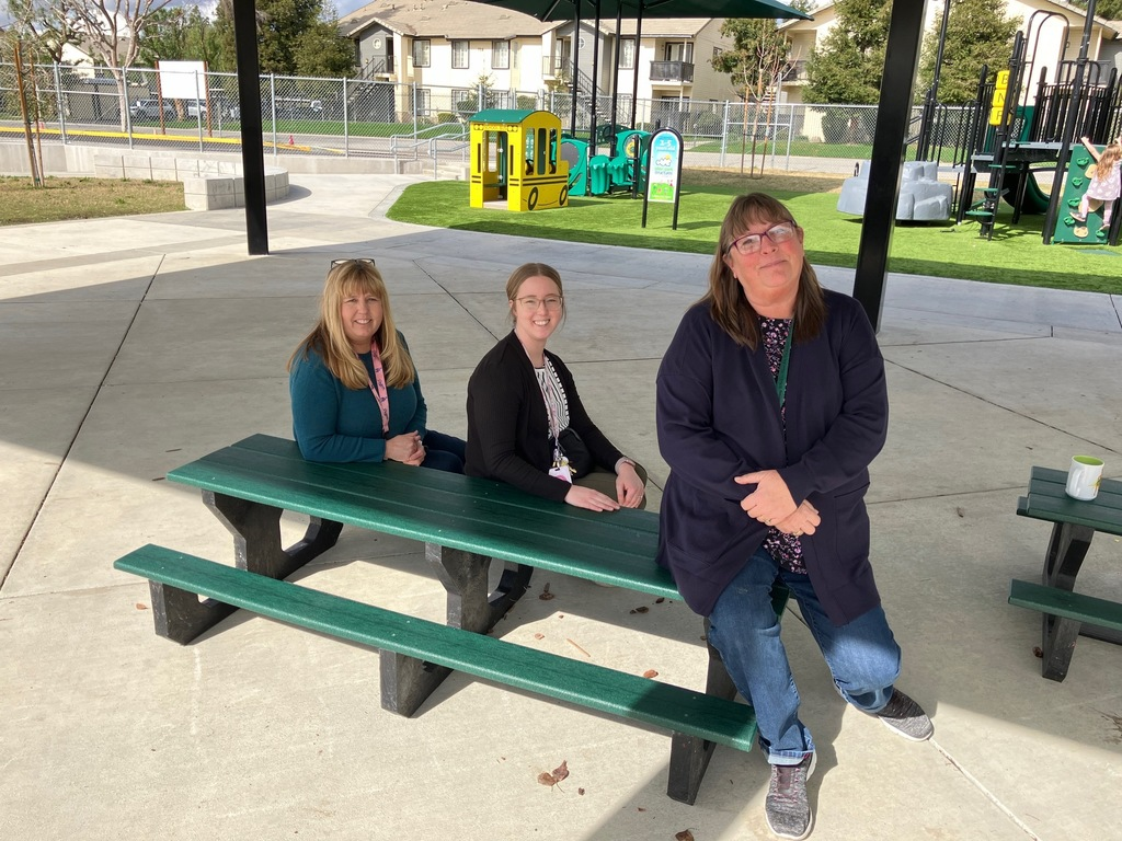 Three women sitting on the new hobbit sized tables