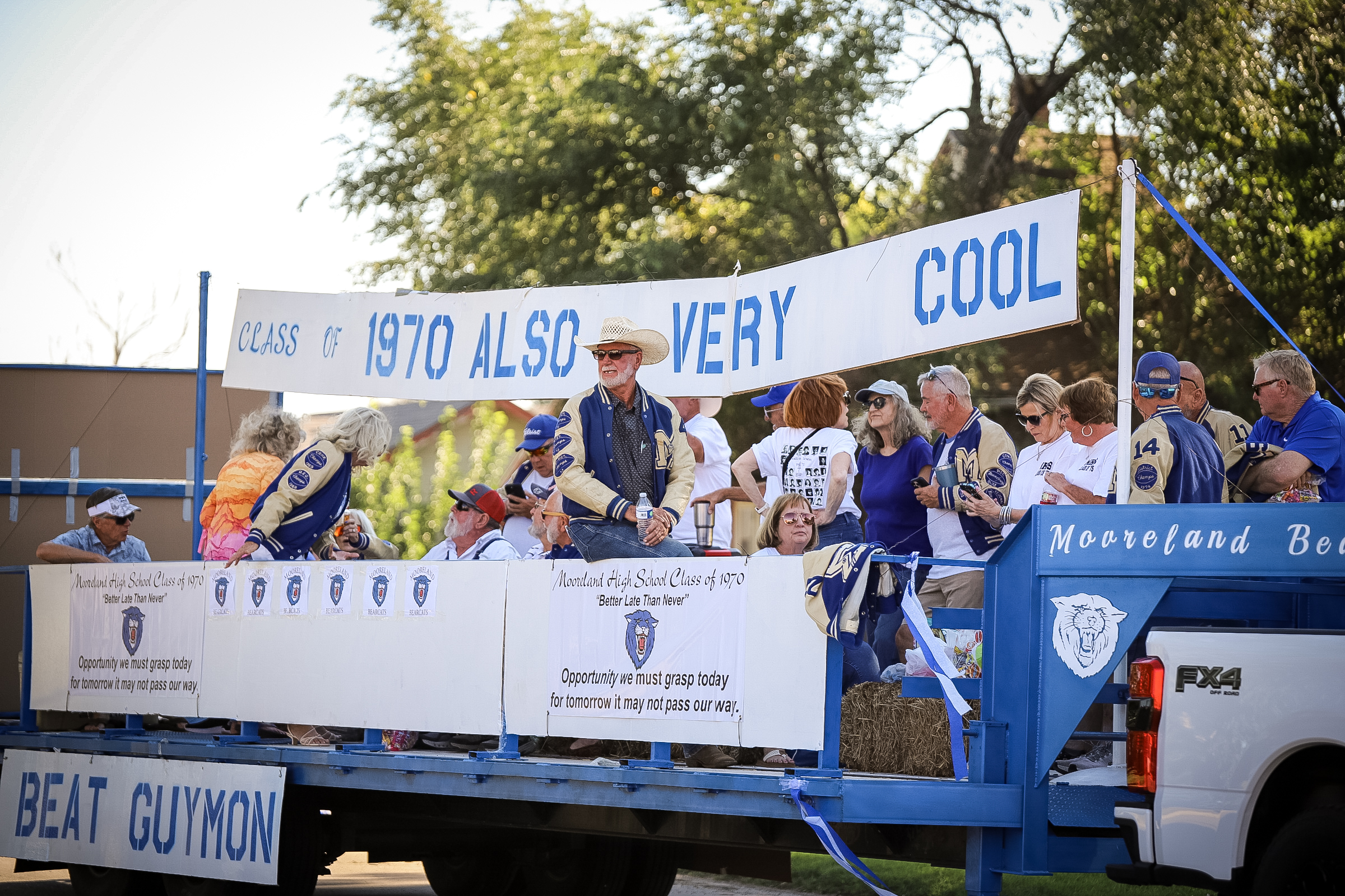 Alumni on a homecoming parade float.