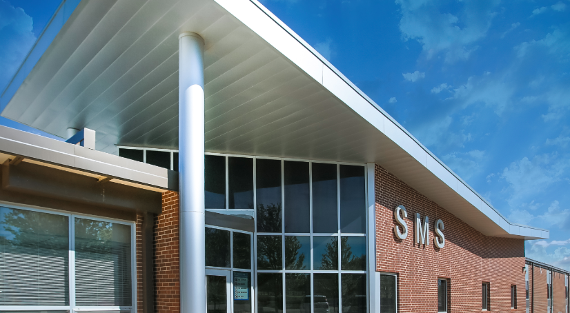 Exterior view of a modern brick building with a large overhang.