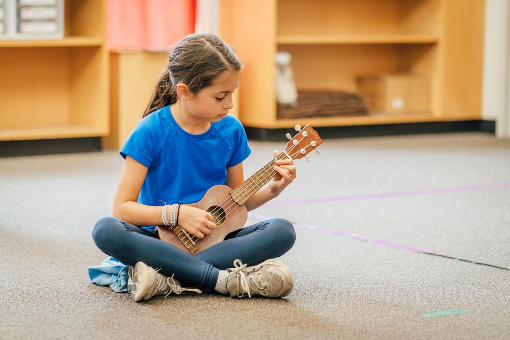 Ambrose student holds a musical instrument