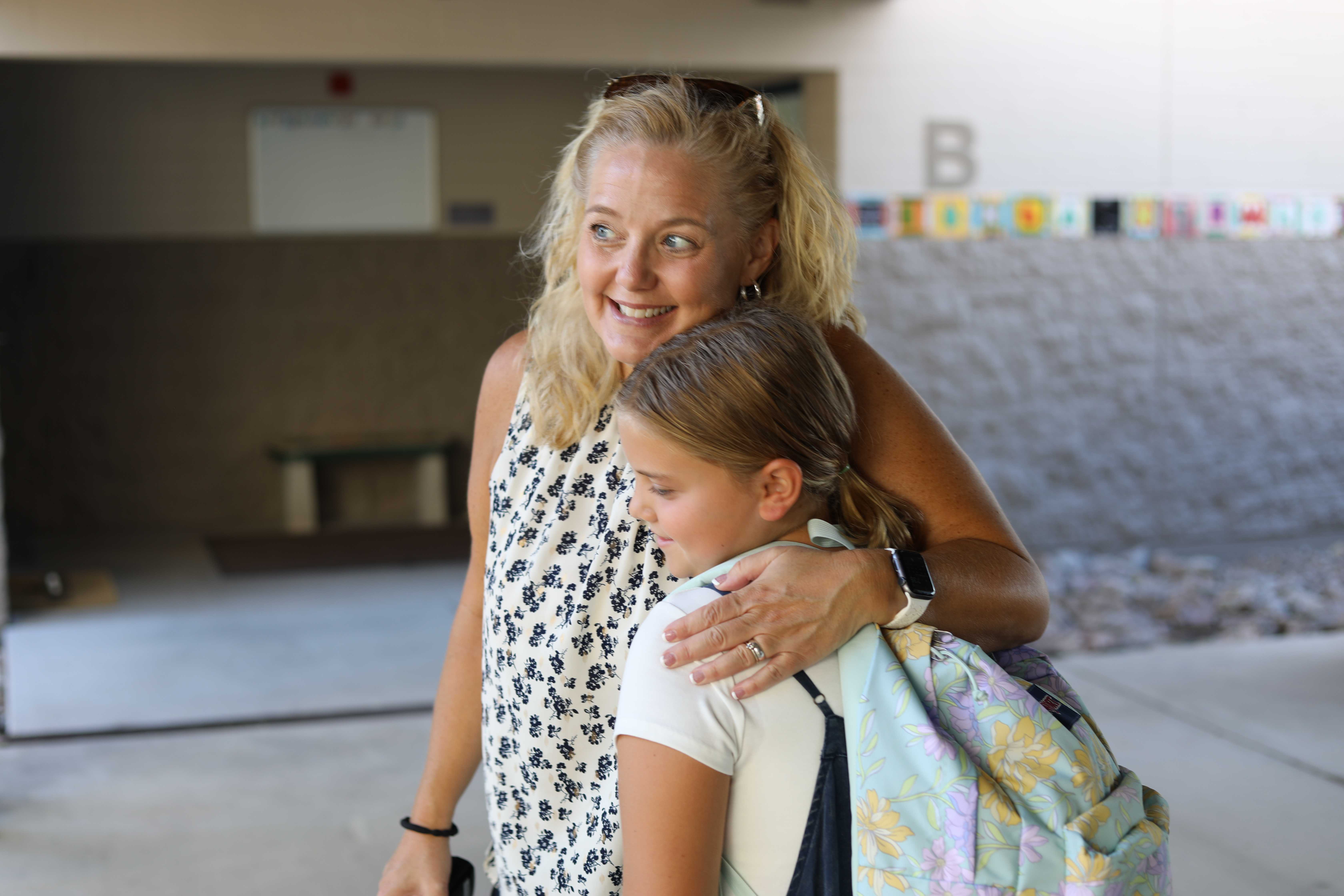 Principal hugs a student