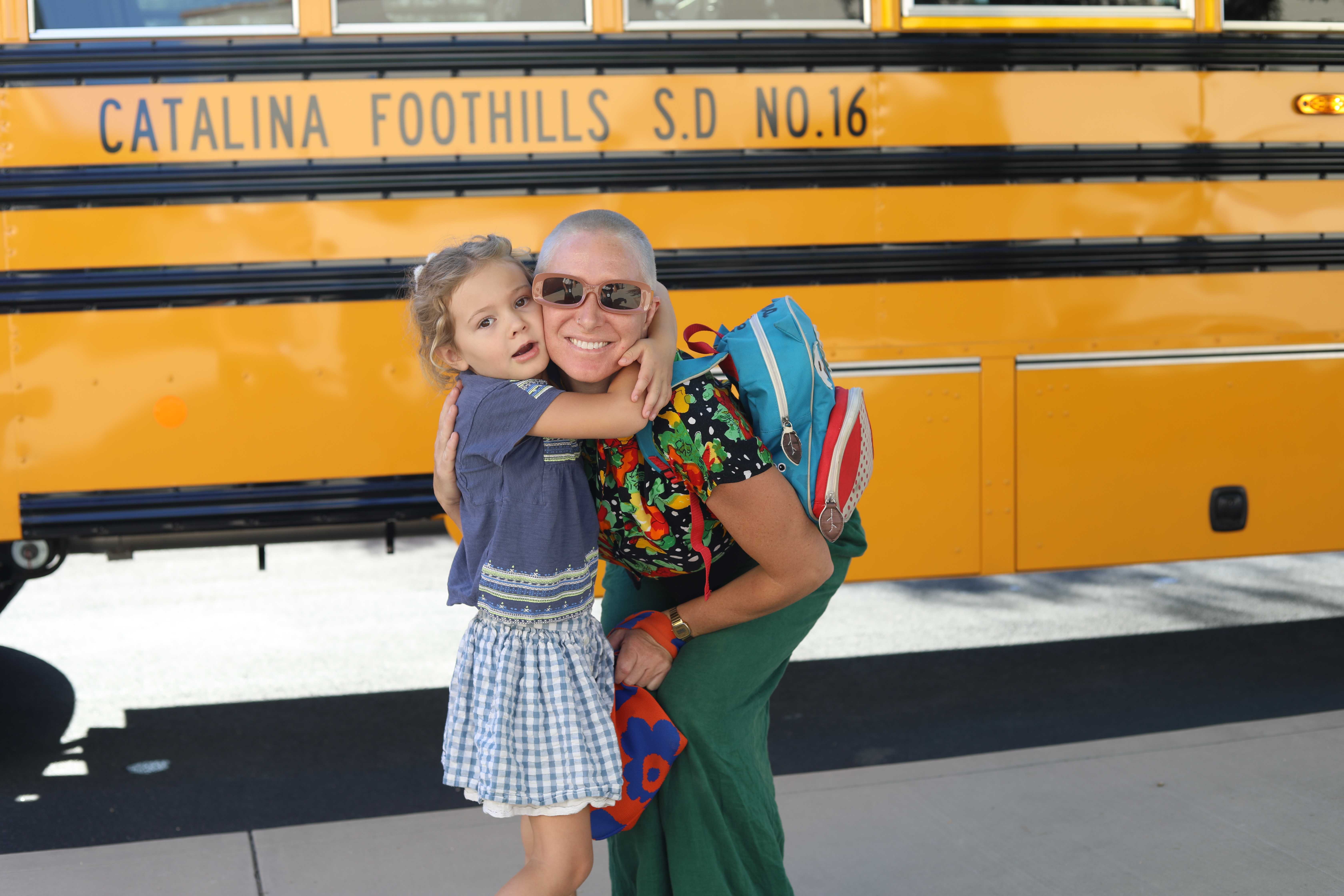 Mom and student in front of a bus
