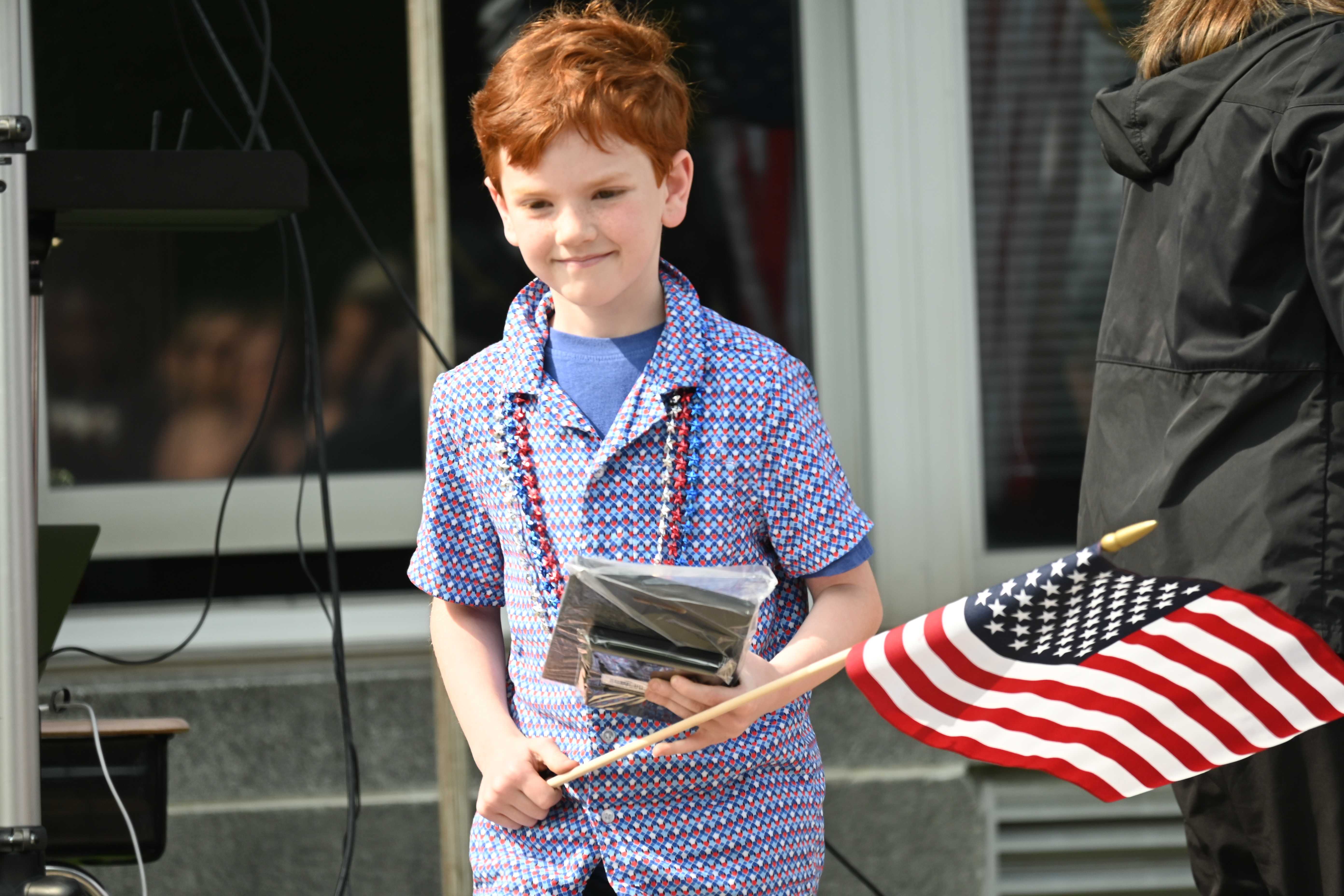 Student with flag during ceremony. 