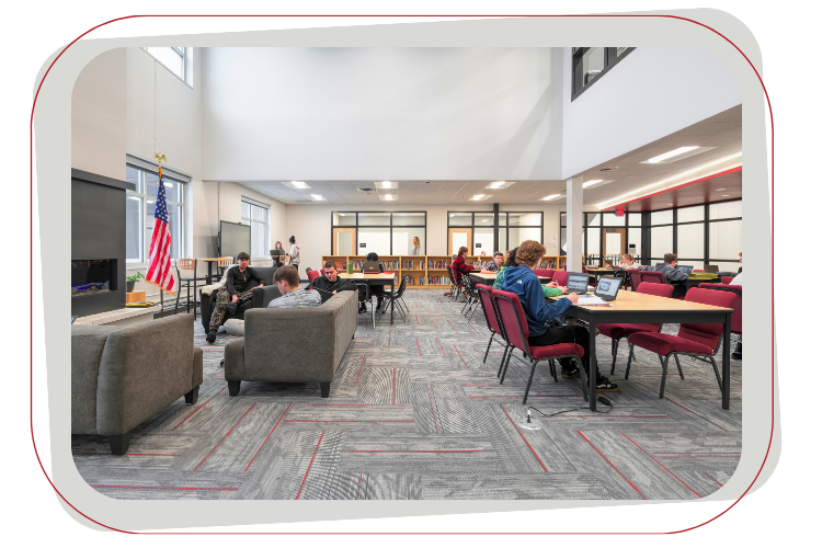 People work and relax in a bright, modern library space.